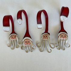 four red and white octopus hair clips with santa claus's hat on them,