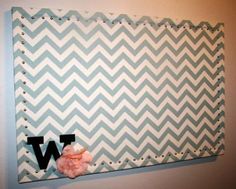 a blue and white chevroned wall hanging with the letter w on it's side