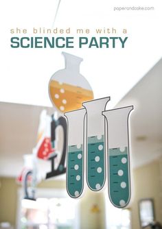 there is a science party sign hanging from the ceiling with beaks in front of them