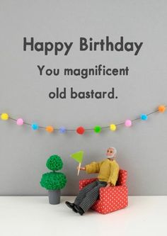 an old man sitting in a chair with a birthday card on the wall behind him