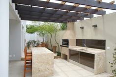 an outdoor kitchen and dining area is shown