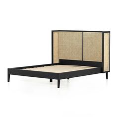 the bed frame is made up with rattan and black wood trimmings on it