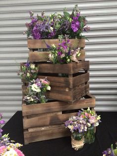 a stack of wooden crates filled with flowers