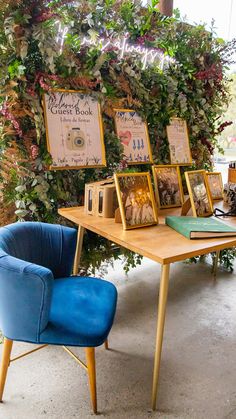 there are many pictures on the table and two chairs in front of them, one is blue