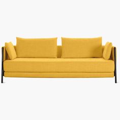 a yellow couch with three pillows on it's back and arms, sitting against a white background