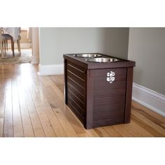 an elevated dog food station with two bowls on top