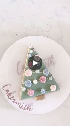 a decorated christmas tree sitting on top of a white plate