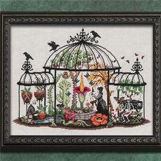 a cross stitch picture with birds in a birdcage