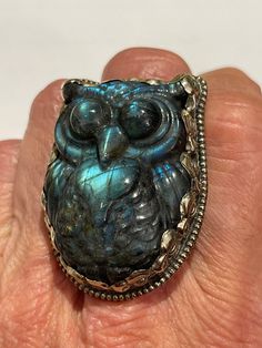 Extremely cool Owl three-dimensional carved labodorite with tons of fire in the stone. The Spectralite glows greens and golds when in direct sunlight, it will be the center attraction on your hand. It measures 1 1/4 inches across, it's about 1 1/2 inches tall. Fully adjustable, hand carved in Nepal. Artisan Carved Adjustable Ring, Mystical Carved Jewelry Gift, Adjustable Labradorite Cabochon Ring, Adjustable Cabochon Labradorite Ring, Adjustable Mystical Labradorite Rings, Unique Carved Adjustable Rings, Handmade Green Labradorite Rings, Unique Adjustable Moonstone Ring With Large Stone, Unique Collectible Labradorite Jewelry