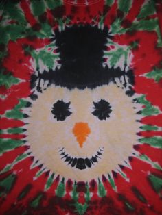 a tie - dyed shirt with an image of a cat's face