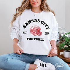 Cheer on the Kansas City football  with this stylish football sweatshirt. Perfect for Chiefs football game day, tailgating, or as a Kansas City football fans gift. Cozy Kansas City pullover for Chiefs football fans. Show your KC pride today! Hey there! 😊👋 Looking for a cozy sweatshirt? You're in the right spot! I'm here to make your shopping experience awesome, so if you have any questions or just want to chat, feel free to reach out anytime. Here's why you'll love these sweatshirts:  ⭐ Cozy & Kc Chiefs Football, Tailgate Gear, Football Sweater, Kansas City Football, Chiefs Football, Gifts For Football Fans, Football Sweatshirt, Kc Chiefs, Football Game