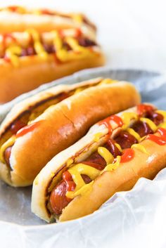 two hot dogs with ketchup and mustard on them