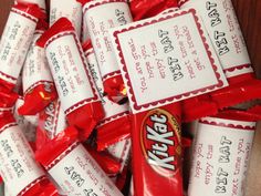 a pile of kitkat candy sitting on top of a wooden table