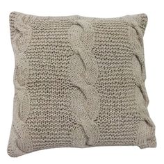 a beige knitted pillow on a white background