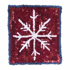 a red and white snowflake with blue trim on it's edges is shown in the shape of a square