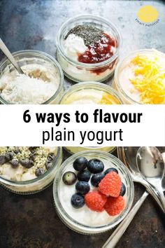 six jars filled with yogurt and fruit on top of a table next to spoons