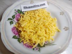 a white plate topped with lots of cheese