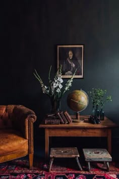 a living room filled with furniture and a globe on top of a wooden coffee table