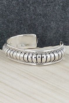 This sterling silver bracelet was made by Navajo silversmith Manuel Johnson. The inside is signed MJ and stamped sterling.Size: 5 5/8" (will fit up to a 6 7/8" wrist)Gap: 1 1/4"Width: 5/8"Free shipping on all orders! We ship with USPS and always include tracking. All orders ship within a day of payment.Returns are accepted up to 30 days after you receive your order. Just send us a message. Our shop offers cash back or store credit. The item must be returned in new condition. Bohemian Sterling Silver Cuff Bracelet With Jubilee Design, Sterling Silver Southwestern Round Cuff Bracelet, Southwestern Sterling Silver Round Cuff Bracelet, Nickel-free Southwestern Sterling Silver Bracelet, Sterling Silver Bracelet, Sterling Silver Bracelets, Silver Bracelet, Gap, Stamp