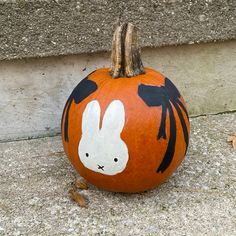 a painted pumpkin with an image of a rabbit on it