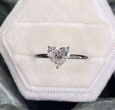 a ring with a heart shaped diamond in it