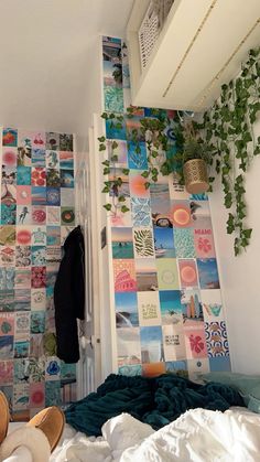 a bedroom with a bed, plants and pictures on the wall