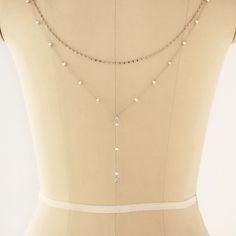 The ultimate backdrop jewelry for a V-shape low back dress! This Pearl Y Lariat Cubic Zirconia chain back jewelry is the perfect accessory. Easy to wear, clips onto your dress. .925 Sterling Silver Freshwater Pearls, 4.5mm Cubic Zirconia Crystals, 5mm + 7mm Hypoallergenic, lead and nickel free Back Length 12 in (30 cm) Note:You must attach loops to dress in order to clip back jewelry #NBC080 2-3 business days Backdrop Jewelry, Back Jewelry Wedding, Backdrop Necklace, Low Back Dress, Backdrops Necklace, Low Back Dresses, Back Necklace, Necklace Bridal, Back Jewelry