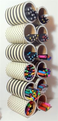 a stack of pencils, markers and pens on a white surface with polka dots