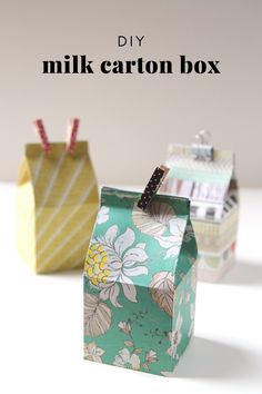 three small boxes with clothes pins in them and the words diy milk carton gift boxes