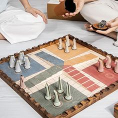 several people playing a board game on the floor