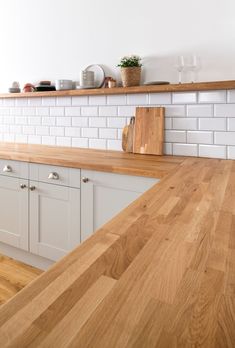 a wooden counter top in a white kitchen