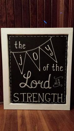 the joy of the lord is strength on a blackboard with white frame and string