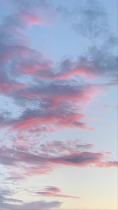 the sky is pink and blue with clouds