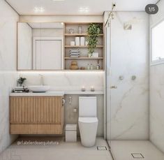 a bathroom with a toilet, sink and shelves in the wall next to each other