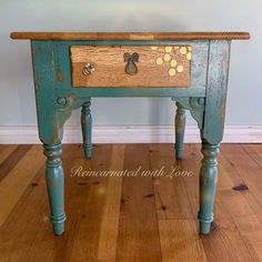 an old wooden table with drawers and knobs on the top is painted blue, yellow and brown