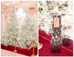 christmas trees in the middle of a red carpeted room and on display at an event