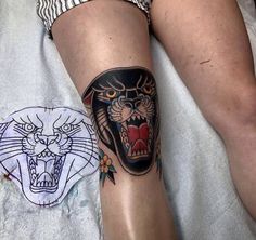 a woman with a tiger tattoo on her leg next to a white and black cat