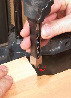 a person using a drill to cut wood