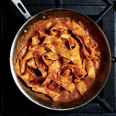 a pan filled with pasta on top of a stove