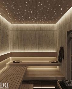 a sauna room with wooden floors and lights on the ceiling, along with two benches