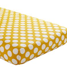 a yellow and white polka dot print sheet