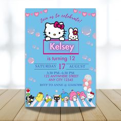 a hello kitty birthday party card on a wooden table