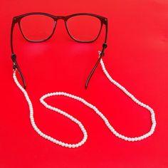 Wear it on your beach trip, dive trip, so you will never lose your glasses / sunglasses! This luxurious-looking eyeglass holder will match any top you are wearing, from shirt, tee, to jacket. Suitable for office attire and casual smart look. #eyeglassholder #sunglassesholder #glassesholder #sunglassesstrap #glassesstrap #glassescord #beachtrip #pearl #fauxpearl #sanurbeach #balibeach #bali #beachnecklace #glassesnecklace #eyeglassholder #glassesjewelry #seablingbling Pearl Glasses, Affordable Necklaces, Sunglasses Cord, Chain Sunglasses, Sunglasses Necklace, Functional Jewelry, Eyeglass Necklace, Gifts For Swimmers, Glasses Chains