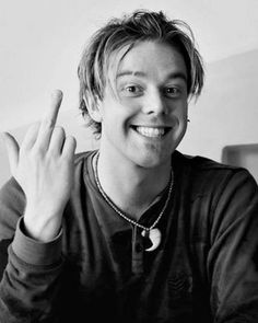 black and white photograph of a man making the peace sign