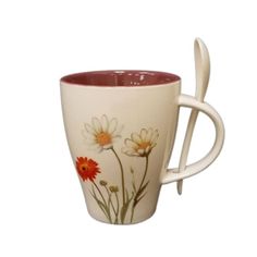 a white coffee cup with flowers painted on it