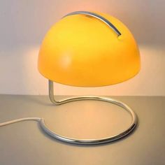 a yellow lamp sitting on top of a table