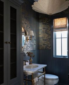 an instagramted photo of a bathroom with dark walls