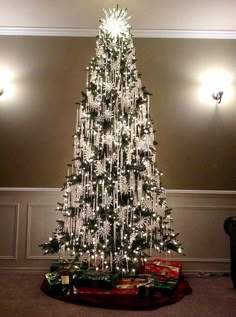 a christmas tree with lights and presents under it