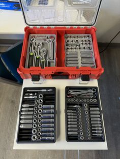 an open tool box filled with tools on top of a table