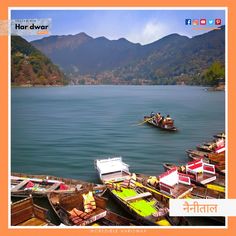 there are many boats in the water and one boat is out on the water with mountains in the background